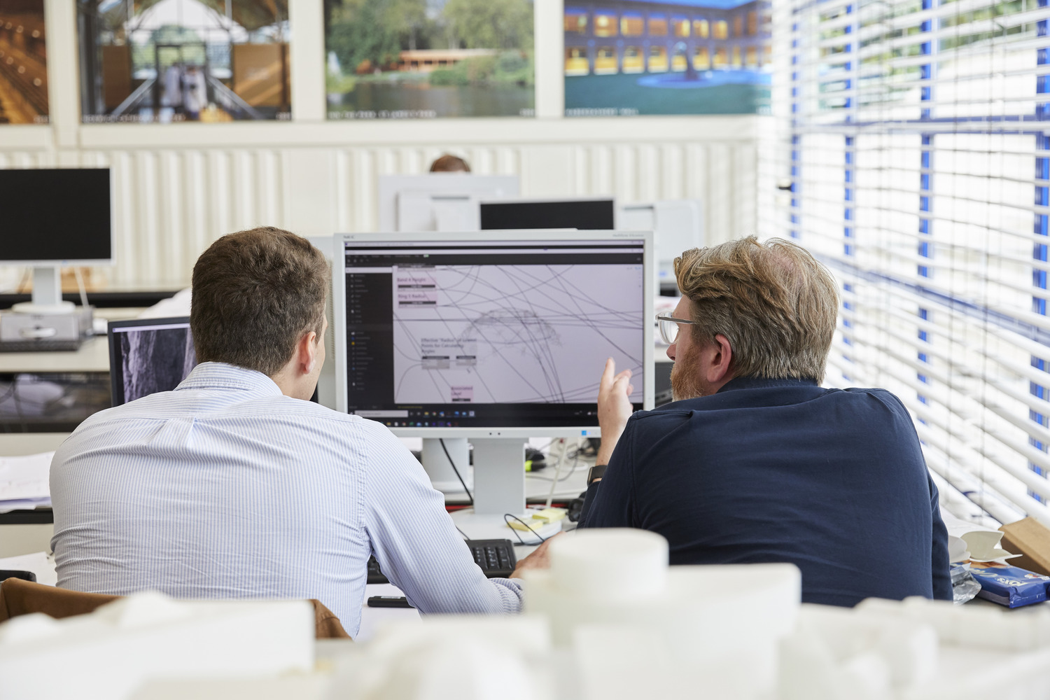 Corrie and a colleague working on a parametric model in the Hopkins Architects office.